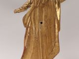 gold statue of a woman with a veil on her head and arms outstretched