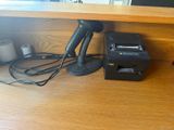 a picture of a desk with a phone and a printer on it