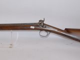 an old rifle with a wooden barrel and a glass holder