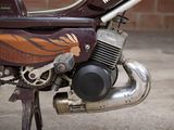 a close up of a motorcycle with a painted design on it