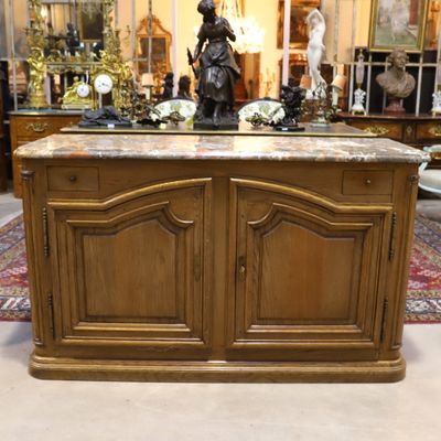 a wooden cabinet with a marble top in a room