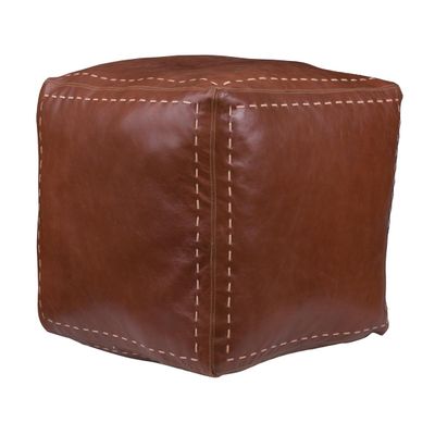un pouf en cuir marron avec des surpiqûres sur les côtés