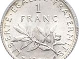 a close up of a one franc coin on a white background