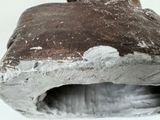 a close up of a piece of clay with a hole in it