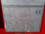 a label on the back of a machine on a red surface