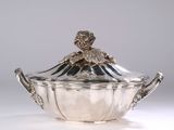 an antique silverplated sugar dish with a flower decoration on the lid