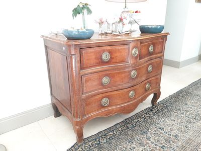 une commode en bois sur laquelle sont posés deux bols bleus