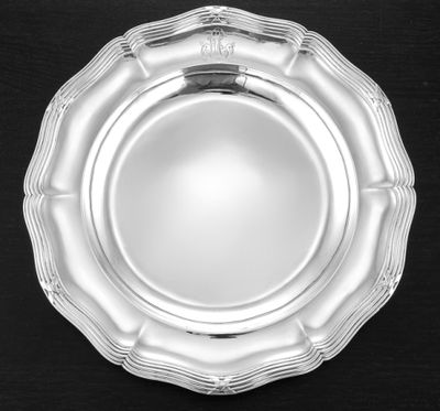 a silver plate that is on a black table