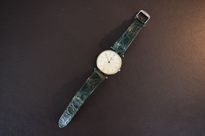 an image of a watch sitting on top of a black surface