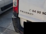a white van that is parked on the side of the road