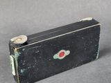 a small black box with a red button on it