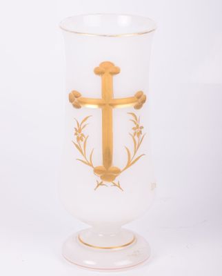 a glass vase with a gold cross on it