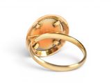an image of a gold ring with an orange stone in the center