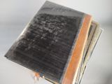 a black book with a brown cover on a white table