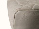 a close up of a white purse on a white surface