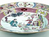a bowl that has a picture of people in a garden on it