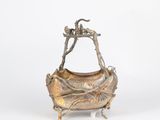 an image of a metal basket with a bird on top of it