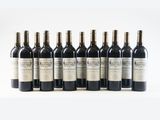 six bottles of wine are lined up in a row on a white surface