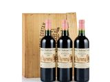 three bottles of red wine in front of a wooden box