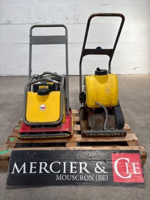 two yellow and black machines on a pallet in a warehouse