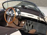 steering wheel and dashboard of a classic sports car with leather seats