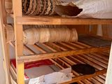 a wooden shelf with baskets on it in a room