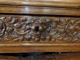 a close up of a carved wooden dresser with drawers