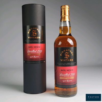 the bottle is next to a black box with a red label on it