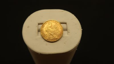 an image of a gold coin sitting on top of a white object