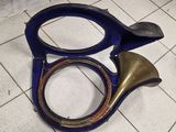 a blue instrument that is laying on the floor