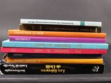 several books are stacked on top of each other on a table