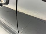 a close up of a car door handle with a hole in it