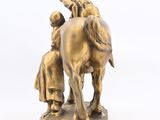 bronze figurine of a man on a horse and a woman on a horse