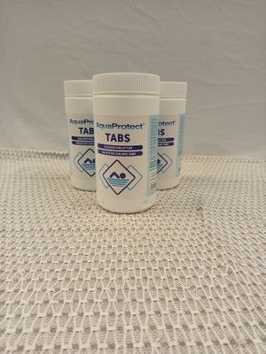 three bottles of tabs sitting on top of a table