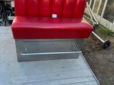 a red bench that is sitting on the ground