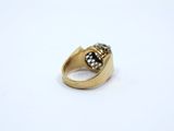a close up of a gold ring with a black stone