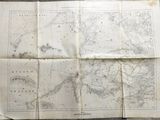 an old map on a table with a piece of paper on top of it