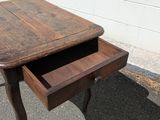 a small wooden table with a drawer underneath it