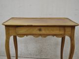 a small wooden table with a drawer on top of it