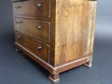 an old wooden chest of drawers sitting on top of a black surface
