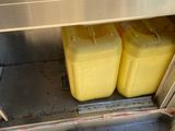 two yellow containers sitting inside of a stainless steel oven