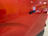 a close up of a red car with a sticker on it
