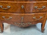 a small wooden chest of drawers with a mirror on top