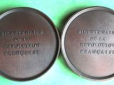 two metal tins with the names of different countries on them