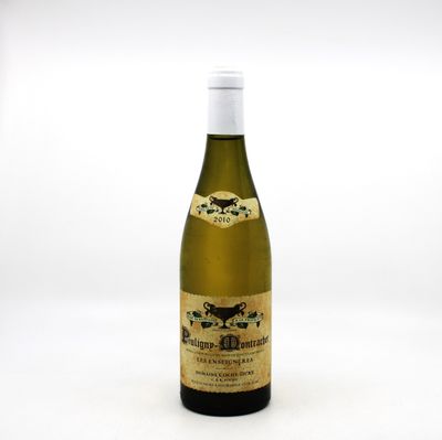 the bottle of wine is sitting on a white surface