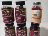 four jars of beet root sit on a table next to a bottle of beet root