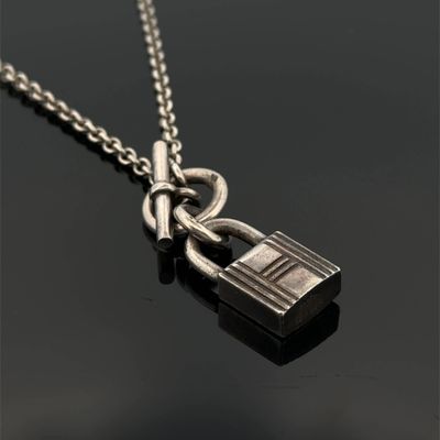 a close up of a padlock on a chain on a black surface