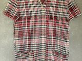 a red and black checkered shirt hanging on a hanger