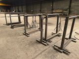 four tables that are sitting in a warehouse