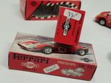 a red toy car that is sitting on top of a box
